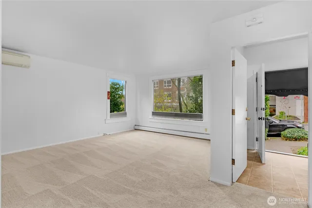 an empty room with windows and closet