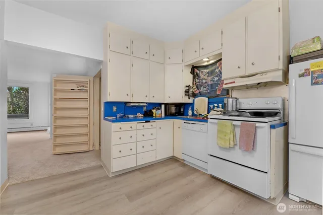a kitchen with appliances cabinets and a window