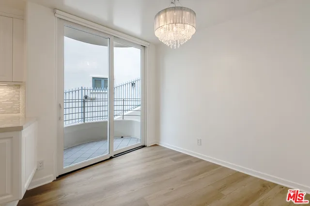 an empty room with wooden floor and door