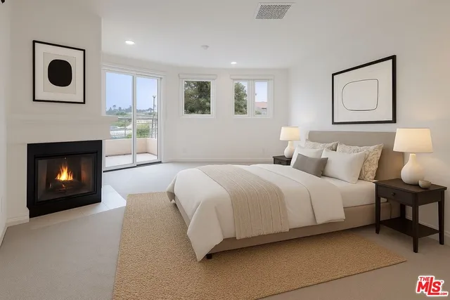 a spacious bedroom with a bed and a fireplace
