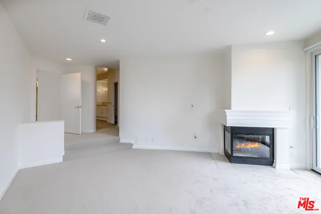 an empty room with a fireplace and a fireplace