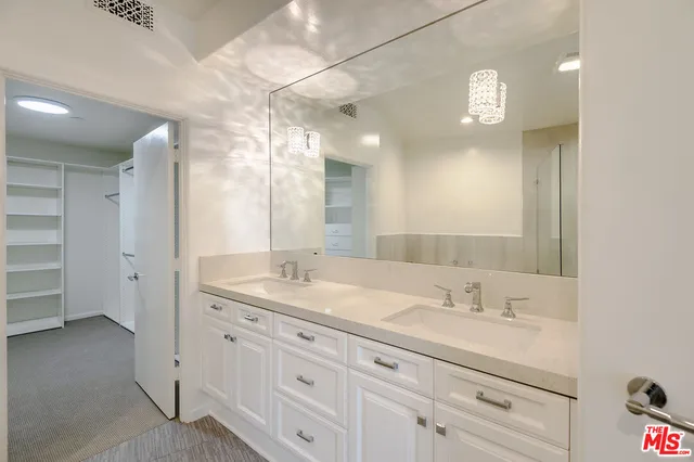 a bathroom with a sink double vanity and a mirror