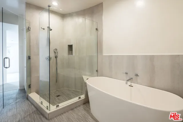 a bathroom with a bathtub and a shower