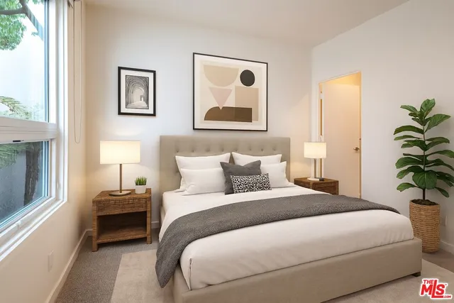 a bedroom with a bed and a painting on the wall