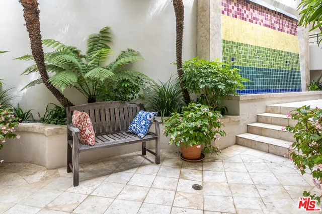 a view of a chairs and table in a backyard