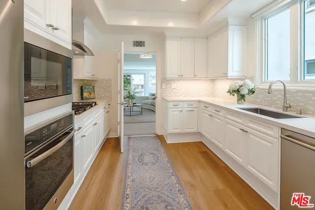 a kitchen with a sink stove and refrigerator