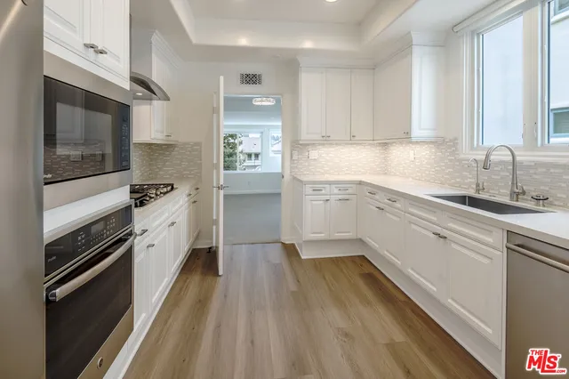 a kitchen with a sink stove and cabinets