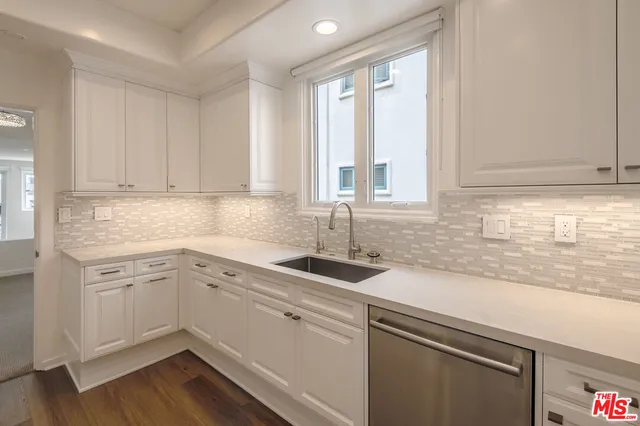 a kitchen with a sink cabinets and window