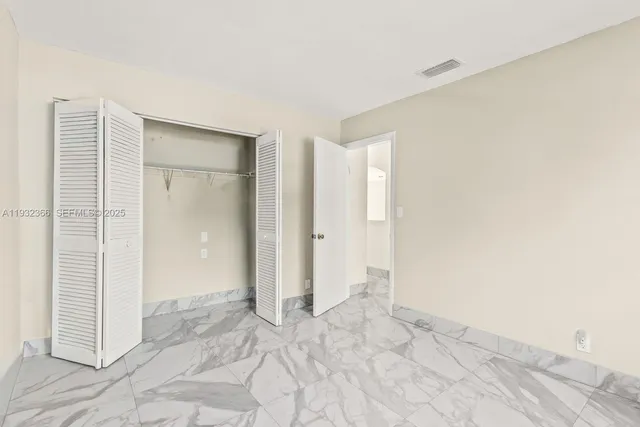 a view of an empty room and a window