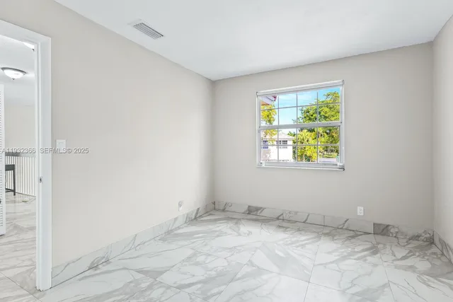 a view of a hallway with wooden floor and entryway
