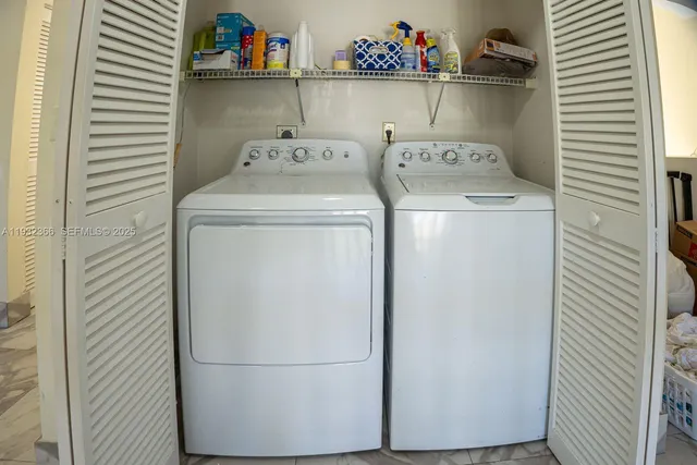 a backyard of a house with large trees and outdoor seating
