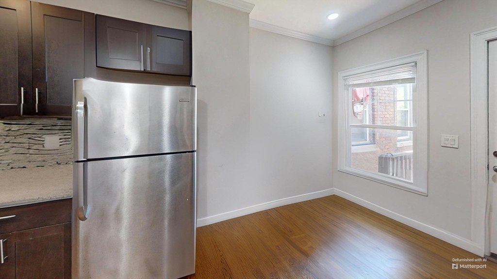 2975 Washington Street, Unit 3 Boston, MA 02119 - Photo 2 of 9 a view of a kitchen with wooden floor and electronic appliances