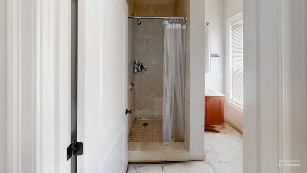 a bathroom with a bathtub and shower