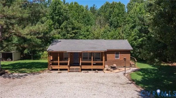 a backyard of a house with barbeque oven and trees