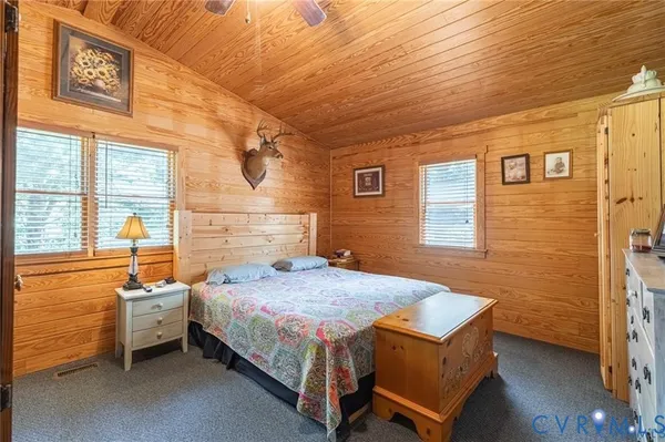 a bedroom with a bed and windows