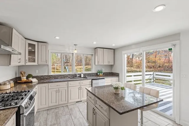 a kitchen with a sink stove and cabinets