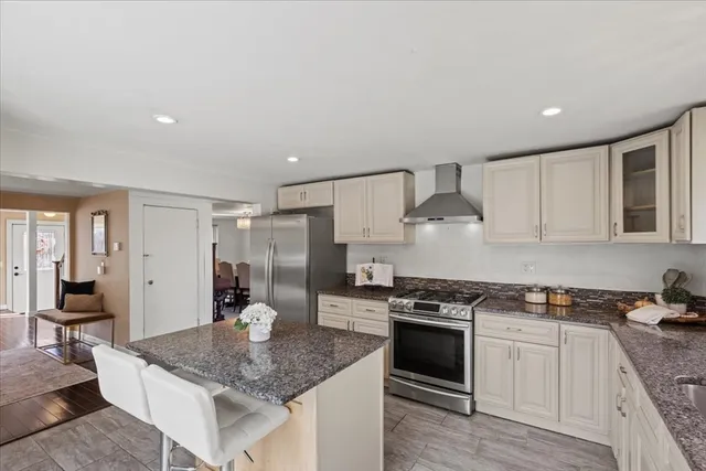 a kitchen with stainless steel appliances granite countertop a sink stove and refrigerator