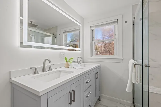 a bathroom with a sink and a window