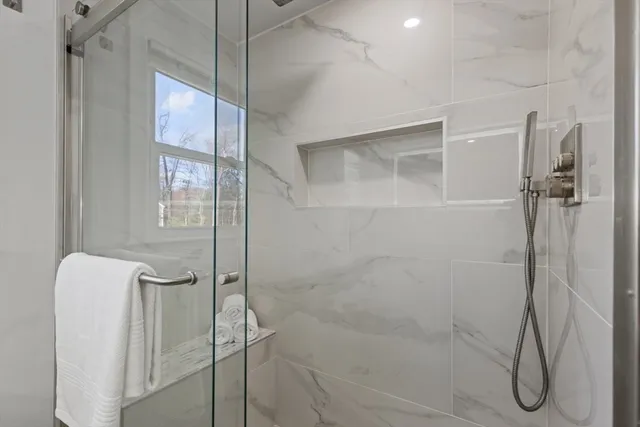 a bathroom with a glass shower door