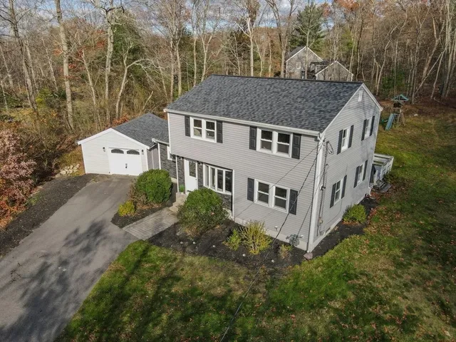 an aerial view of a house next to a yard