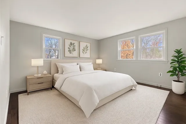 a bedroom with bed and a potted plant