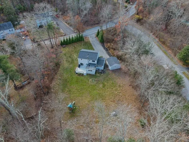 a aerial view of a house with a yard