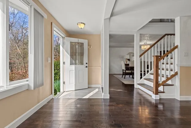 a view of entryway with wooden floor and stairs