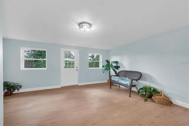 a view of a livingroom with furniture and a window