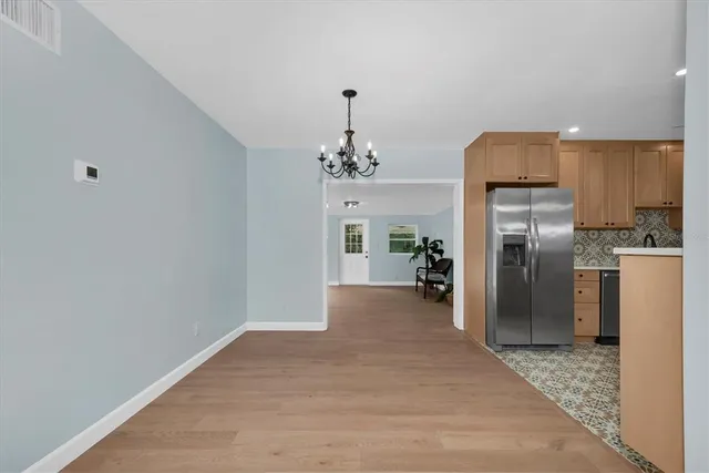 a view of a kitchen with a refrigerator a kitchen a sink and a refrigerator