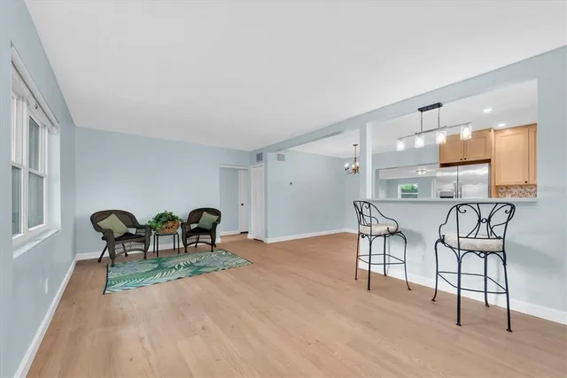 a dining room with furniture and wooden floor
