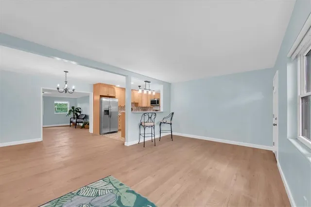 a view of a livingroom with furniture and a kitchen