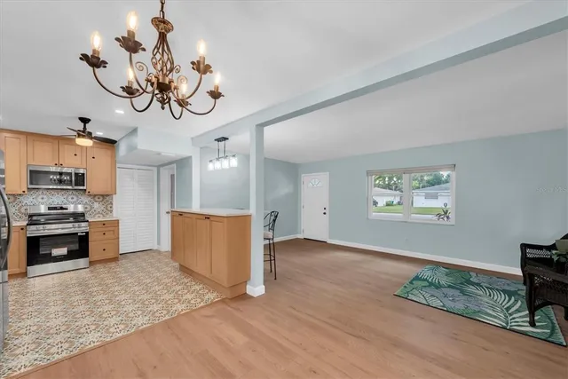 a view of a kitchen with a sink stainless steel appliances and cabinets
