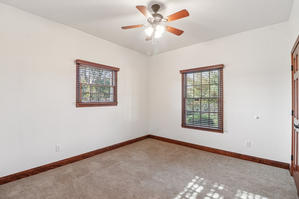 802 Ave C Fredericksburg, TX 78624 - Photo 19 of 22 an empty room with windows and fan