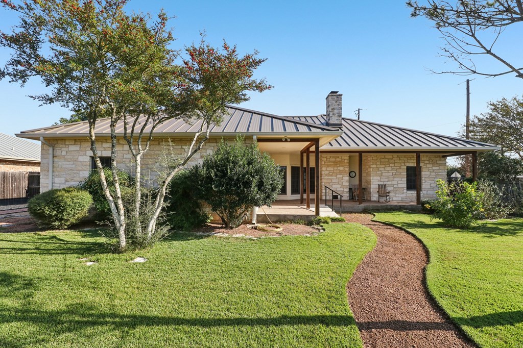 802 Ave C Fredericksburg, TX 78624 - Photo 2 of 22 a view of a house with backyard porch and sitting area