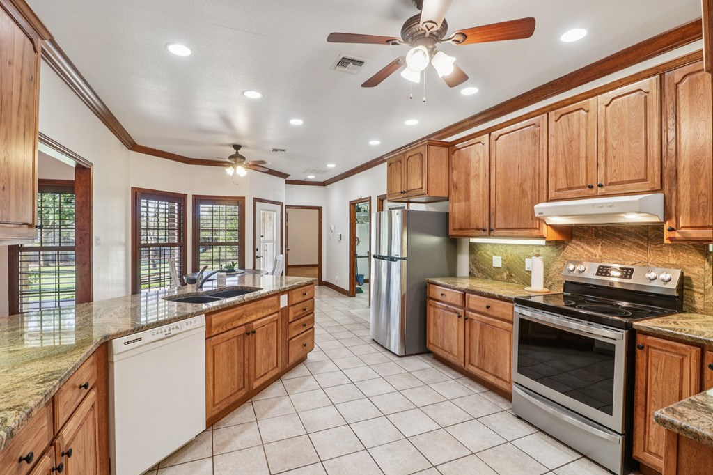 802 Ave C Fredericksburg, TX 78624 - Photo 7 of 22 a kitchen with appliances cabinets and a sink