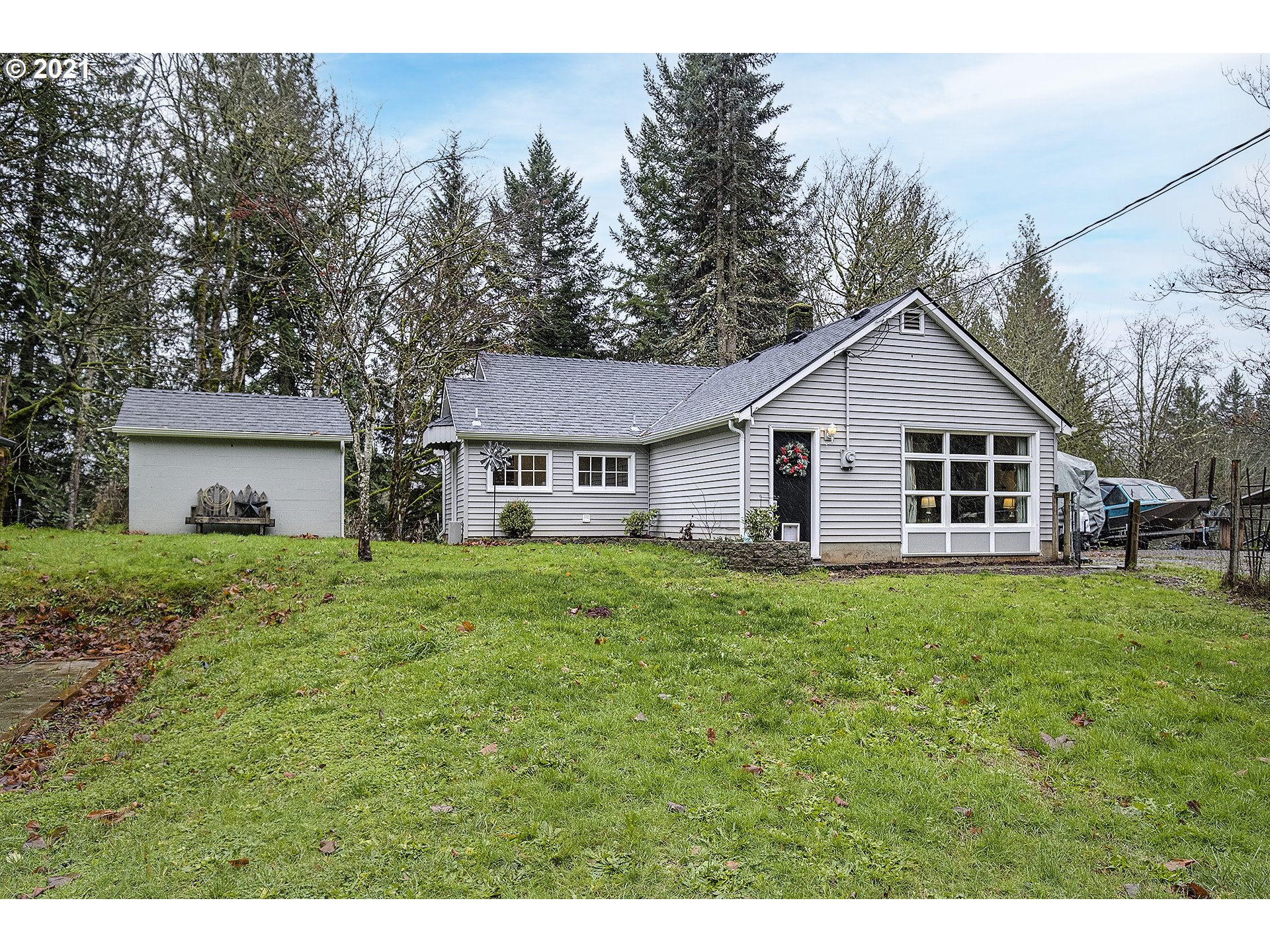 35520 Skogan Road Sandy, OR 97055 - Photo 2 of 25 a view of a yard in front of a house with large trees