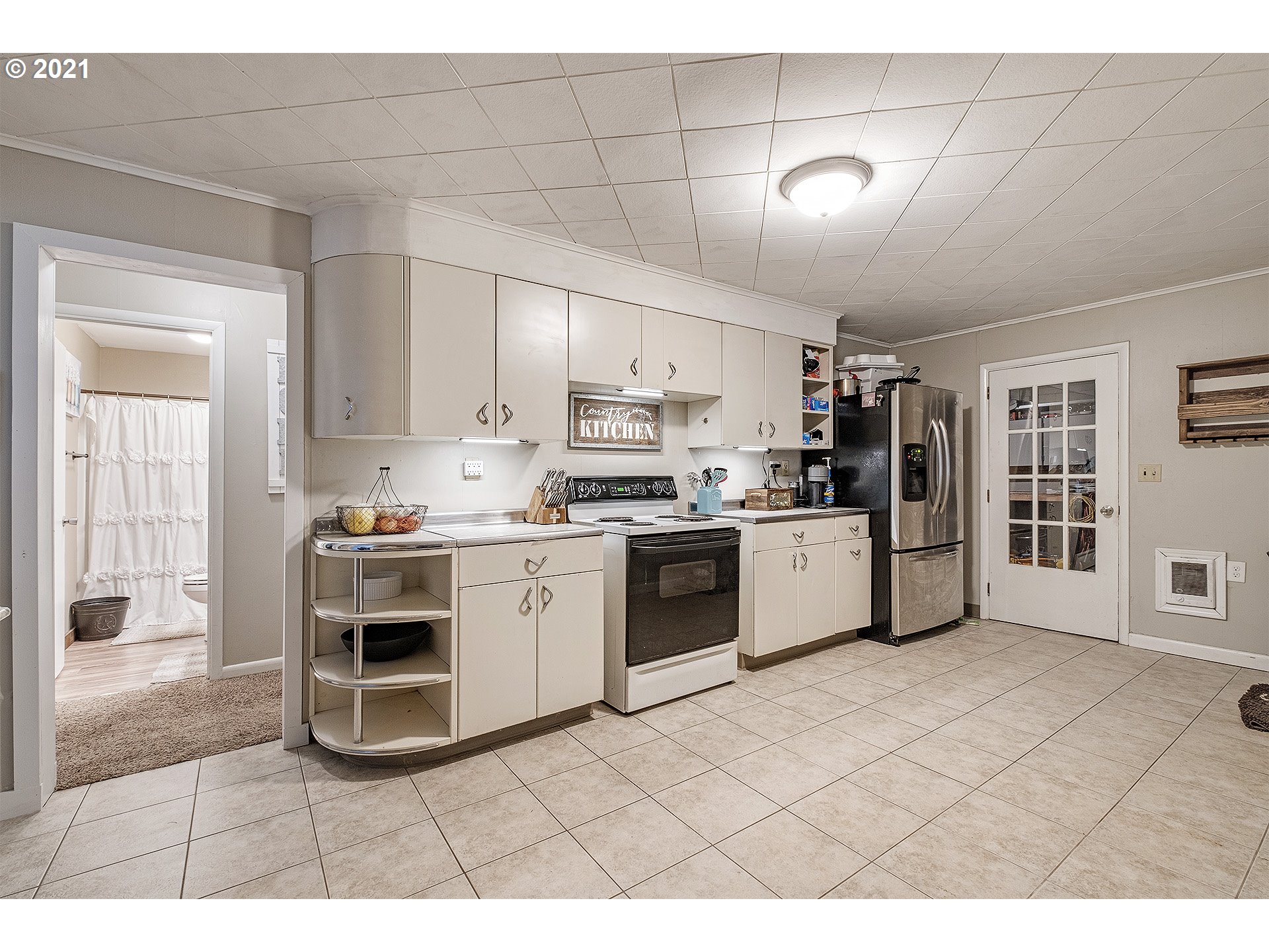 35520 Skogan Road Sandy, OR 97055 - Photo 10 of 25 a kitchen with stainless steel appliances kitchen island granite countertop a refrigerator and cabinets