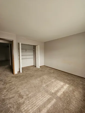 a view of an empty room and closet area