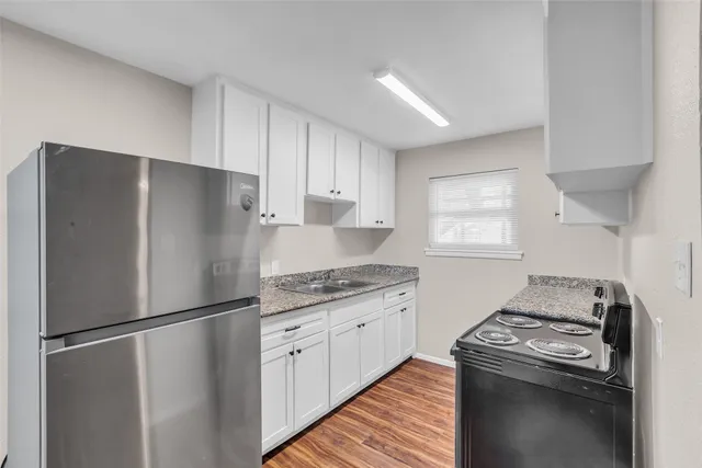a kitchen with a refrigerator stove and sink