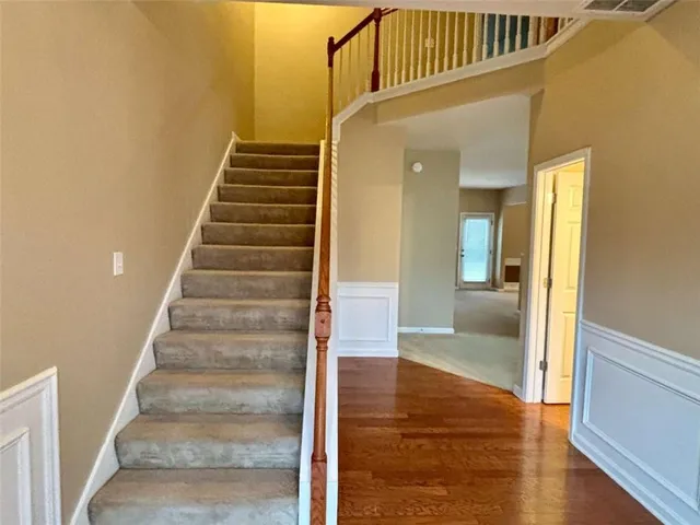 a view of a hallway view with wooden floor and staircase