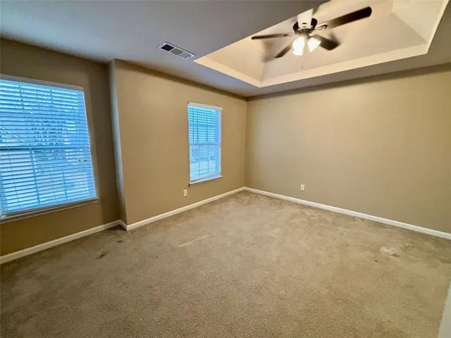 an empty room with closet and a chandelier fan