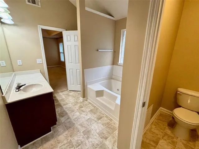a bathroom with a sink double vanity granite and a mirror