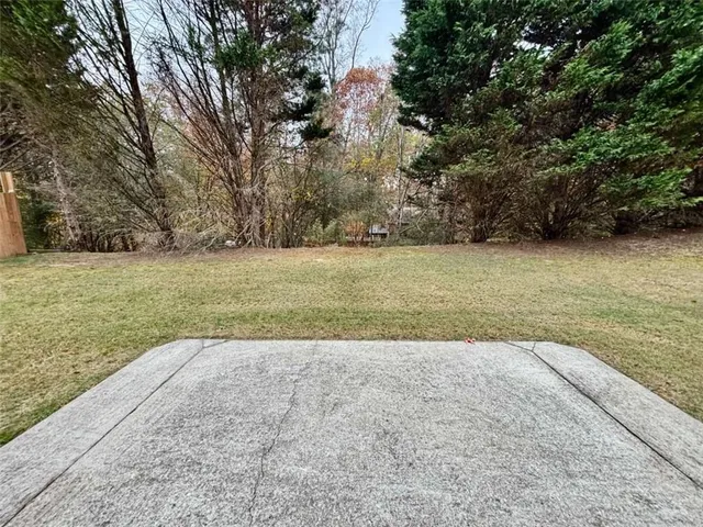 a backyard of a house with yard and outdoor seating