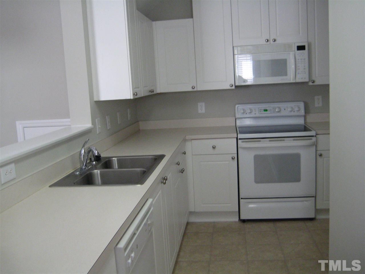 2017 Metacomet Way Raleigh, NC 27604 - Photo 3 of 15 a kitchen with white cabinets and white appliances