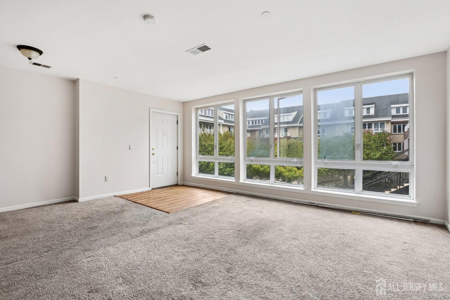 368 Rector Street, Unit 421 Perth Amboy, NJ 08861 - Photo 14 of 37 a view of an empty room with a large window and wooden floor