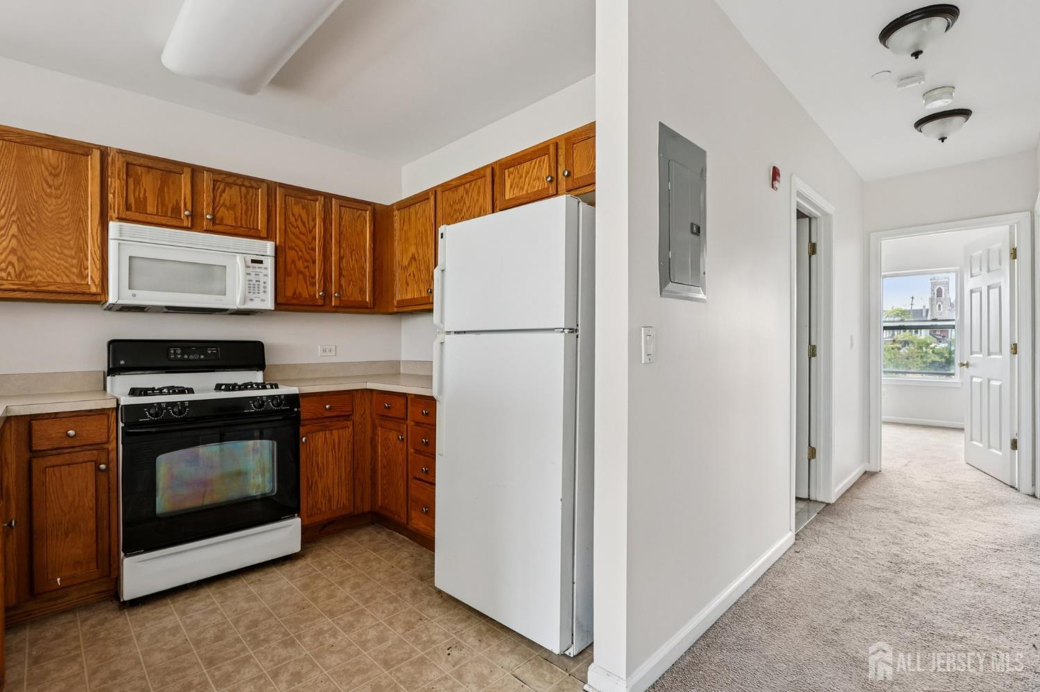 368 Rector Street, Unit 421 Perth Amboy, NJ 08861 - Photo 17 of 37 a kitchen with stainless steel appliances granite countertop a refrigerator stove and sink