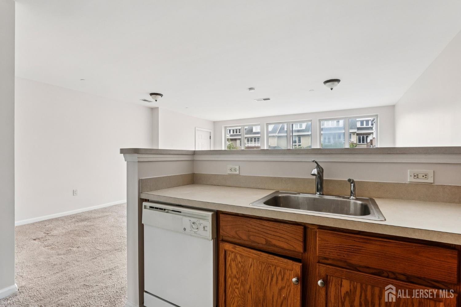 368 Rector Street, Unit 421 Perth Amboy, NJ 08861 - Photo 18 of 37 a kitchen with a sink and a refrigerator