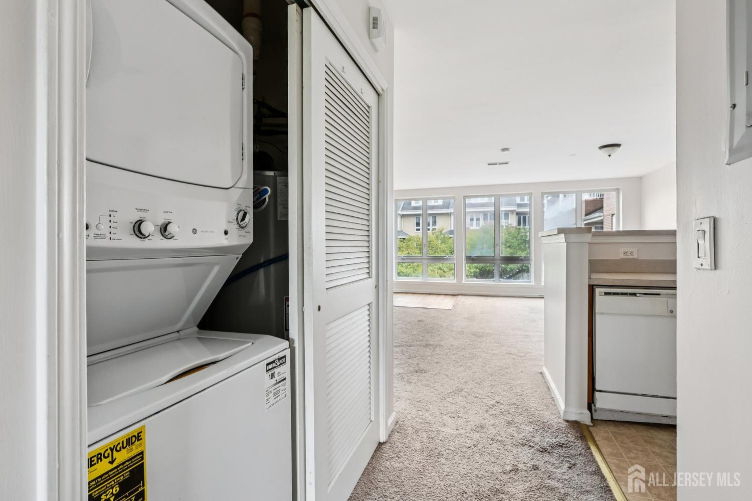 368 Rector Street, Unit 421 Perth Amboy, NJ 08861 - Photo 26 of 37 a kitchen with a refrigerator and white cabinets