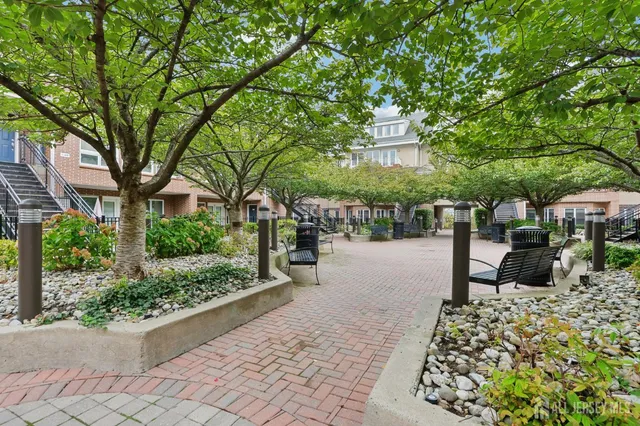a view of a patio with a table and chairs and potted plants