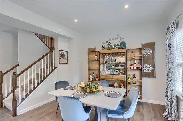 a view of a dining room with furniture a chandelier and wooden floor